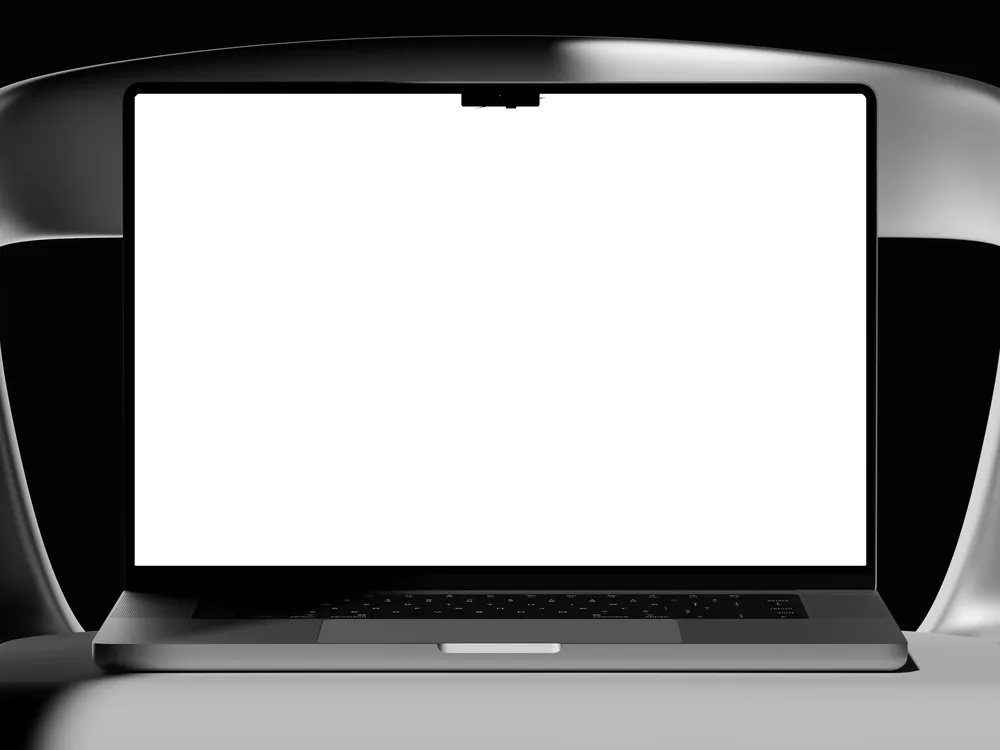 A MacBook Pro on a sculptural chair, the wallpaper on its screen